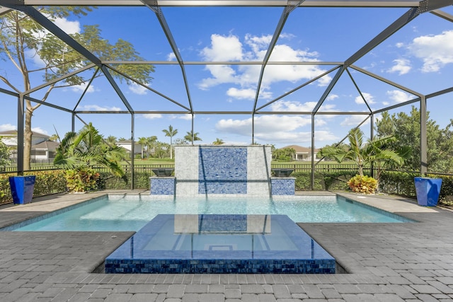 view of pool with an in ground hot tub, a patio, and a lanai