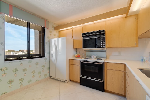 kitchen with a textured ceiling, light brown cabinetry, and white appliances