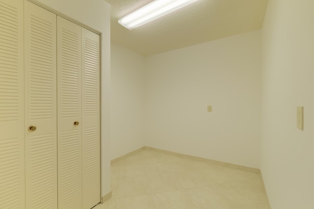 unfurnished bedroom featuring a closet and a textured ceiling