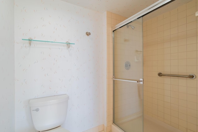 bathroom featuring toilet and walk in shower