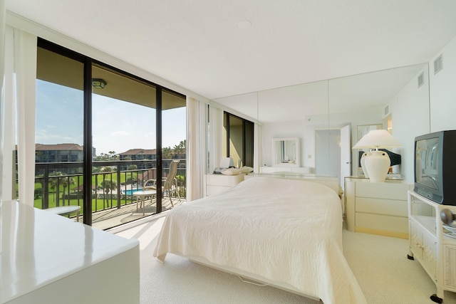 carpeted bedroom featuring access to outside and floor to ceiling windows