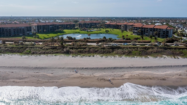 bird's eye view with a water view and a beach view