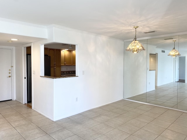 unfurnished room with light tile patterned floors, an inviting chandelier, and ornamental molding