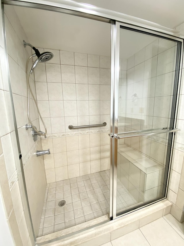 bathroom with tile patterned floors and walk in shower