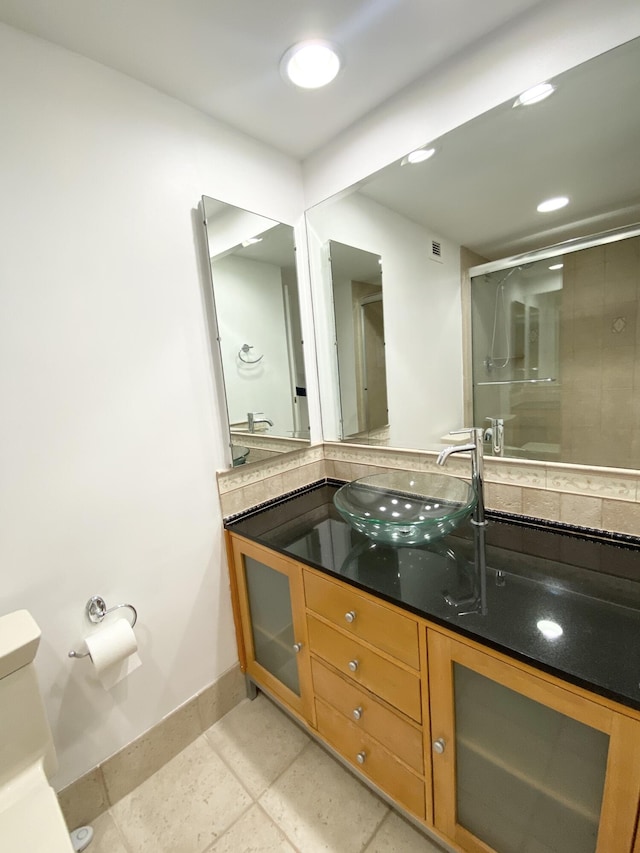 bathroom with tile patterned floors, vanity, and toilet