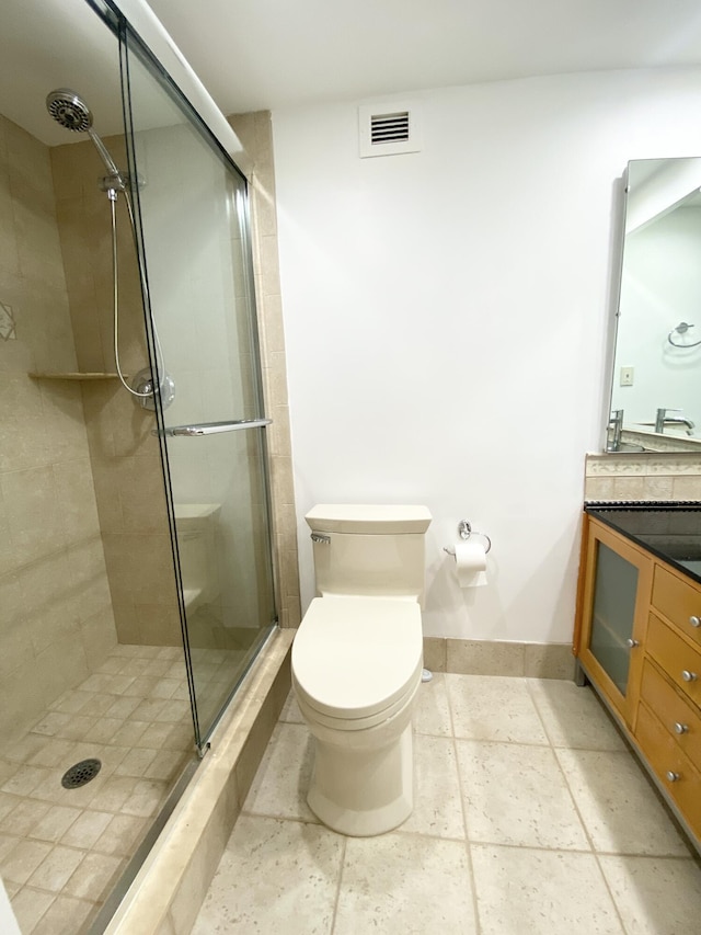 bathroom with an enclosed shower, vanity, and toilet