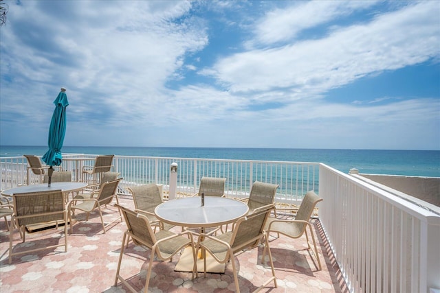 view of patio / terrace with a water view and a view of the beach