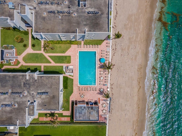 birds eye view of property featuring a water view and a view of the beach