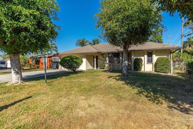 single story home featuring a front lawn