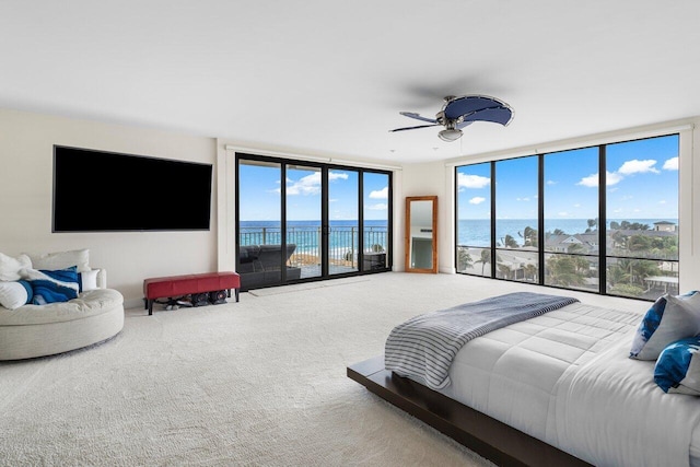 carpeted bedroom with access to outside, floor to ceiling windows, and ceiling fan