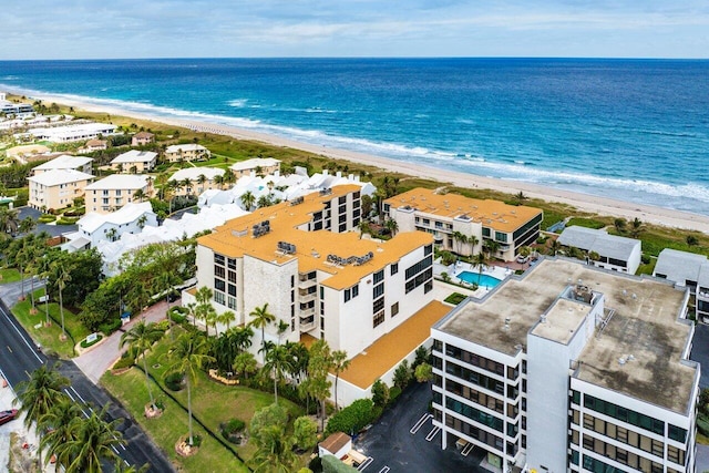 drone / aerial view featuring a water view and a beach view