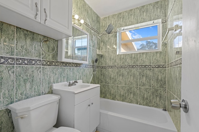 full bathroom with vanity, toilet, tile walls, and tiled shower / bath combo