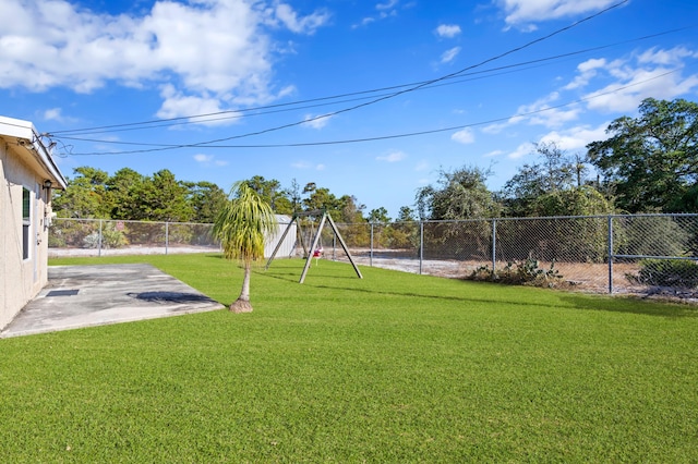 view of yard featuring a playground and a patio area