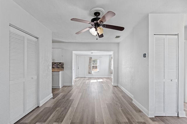 corridor with light hardwood / wood-style floors