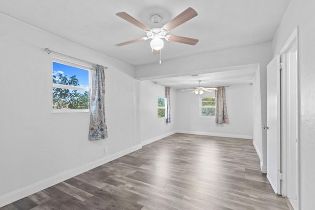 empty room featuring hardwood / wood-style flooring and ceiling fan