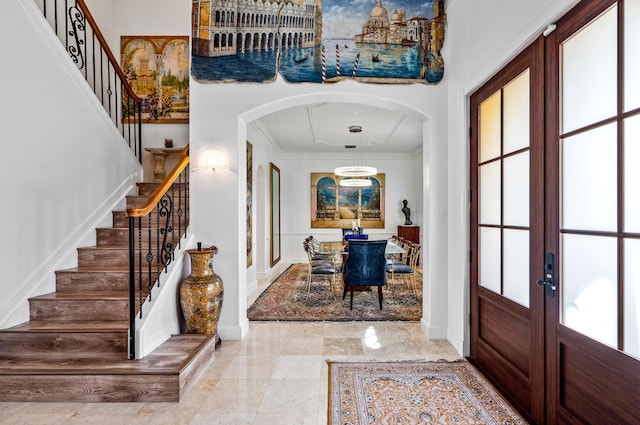 entryway featuring french doors and ornamental molding