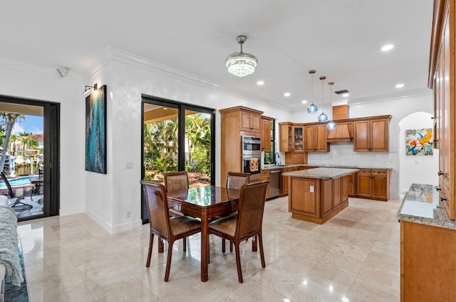 dining room featuring ornamental molding, a healthy amount of sunlight, and a notable chandelier