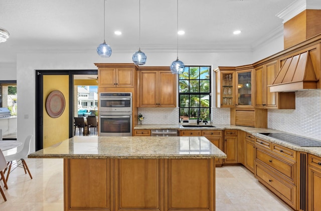 kitchen featuring sink, pendant lighting, custom range hood, a kitchen island, and stainless steel appliances