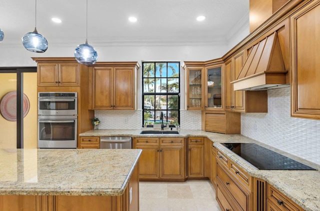 kitchen featuring appliances with stainless steel finishes, light stone countertops, decorative light fixtures, sink, and custom exhaust hood