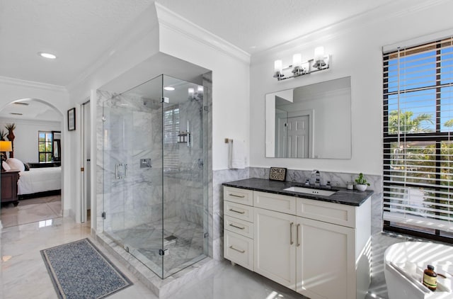 bathroom featuring vanity, an enclosed shower, ornamental molding, and a textured ceiling