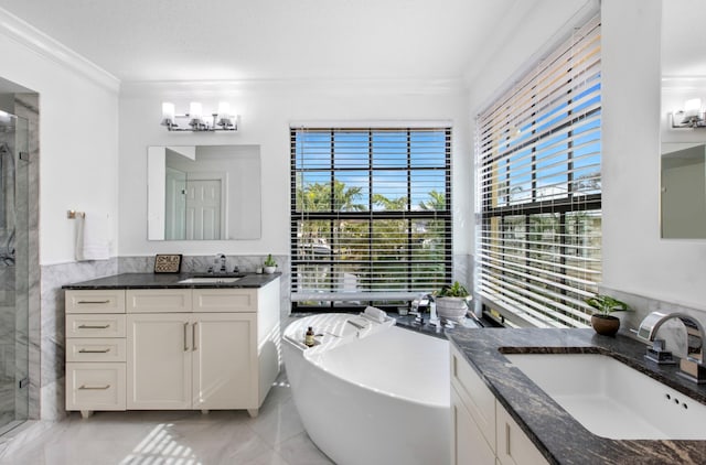 bathroom with ornamental molding, separate shower and tub, tile walls, and vanity