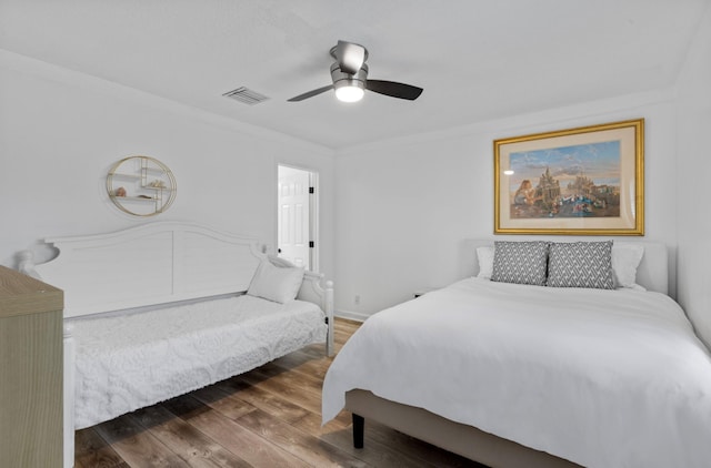 bedroom featuring crown molding, ceiling fan, and dark hardwood / wood-style floors