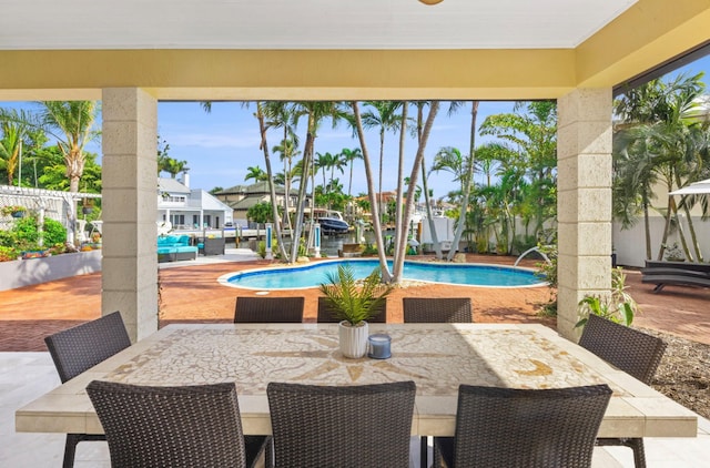 view of swimming pool featuring ceiling fan and a patio area