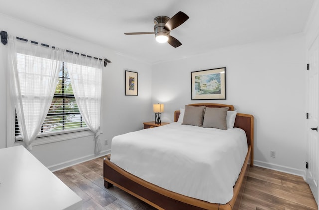 bedroom featuring ceiling fan and dark wood-type flooring