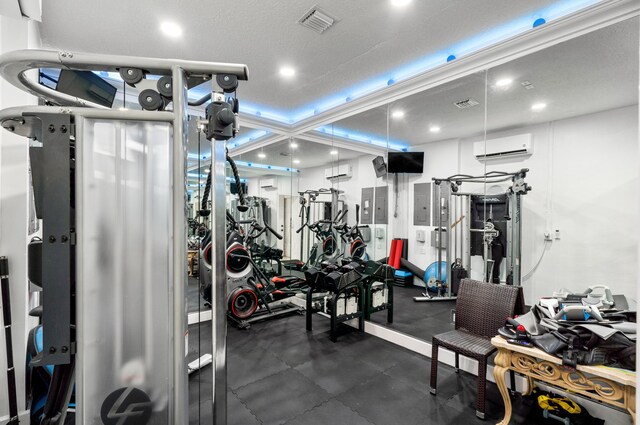 gym featuring coffered ceiling and a wall unit AC