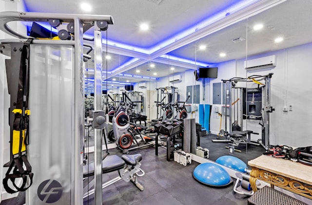 exercise room featuring a wall mounted AC and coffered ceiling