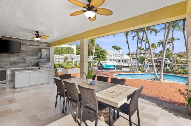 view of patio / terrace with ceiling fan, a grill, area for grilling, and a fenced in pool