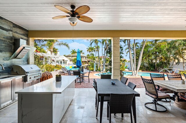 view of patio / terrace with area for grilling, ceiling fan, and grilling area