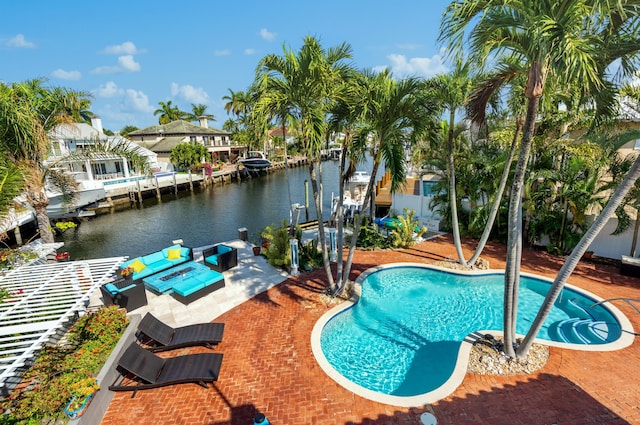 view of pool featuring a patio area, a water view, and a dock