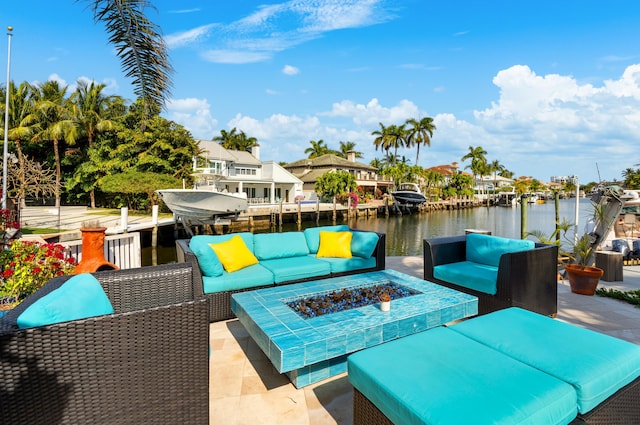 view of patio / terrace with a water view and an outdoor living space with a fire pit