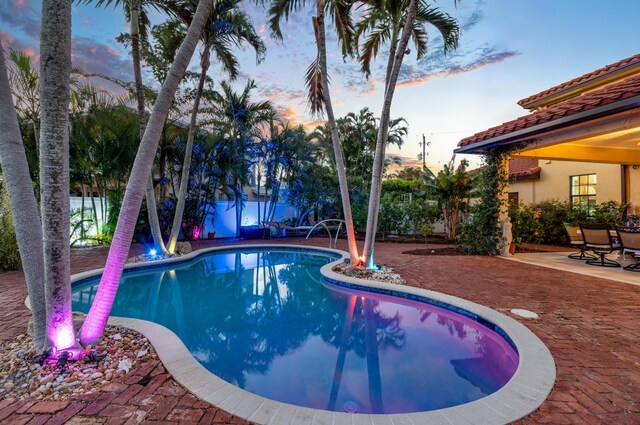 view of patio / terrace featuring a water view and an outdoor living space with a fire pit