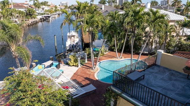 view of swimming pool with a water view and a patio area