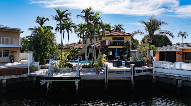 view of dock with a water view and a balcony