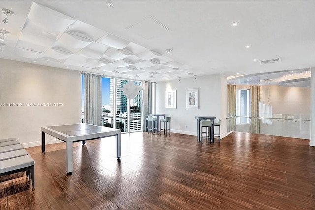 rec room featuring hardwood / wood-style flooring, a wall of windows, and a healthy amount of sunlight