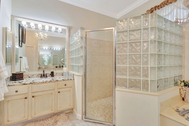 bathroom featuring a shower with door, vanity, an inviting chandelier, and ornamental molding