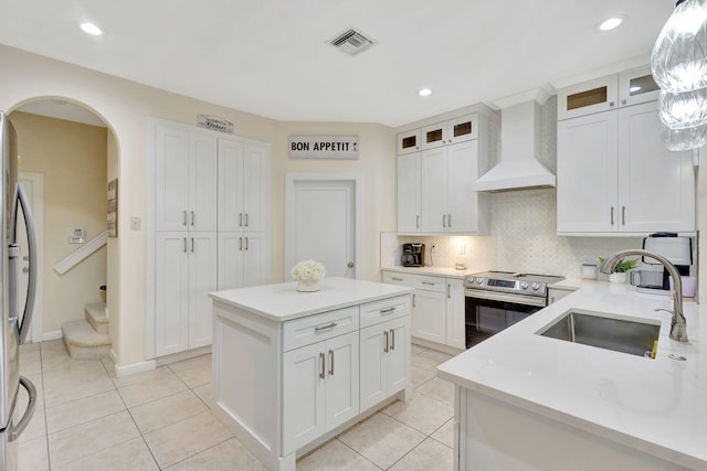 kitchen with white cabinetry, sink, a center island, stainless steel appliances, and custom exhaust hood