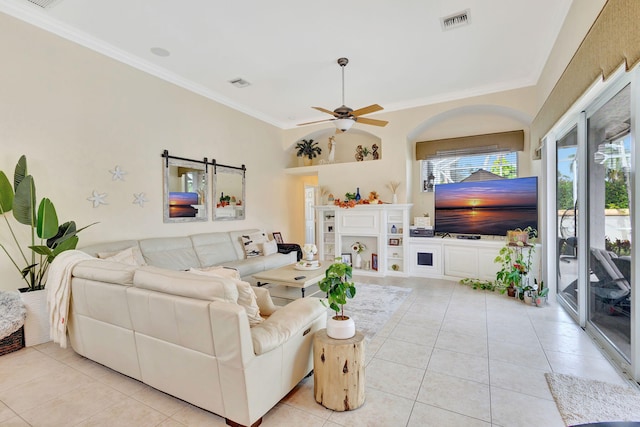 living room featuring light tile patterned floors, ceiling fan, and ornamental molding