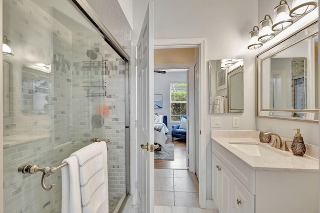 bathroom featuring tile patterned flooring, vanity, and an enclosed shower