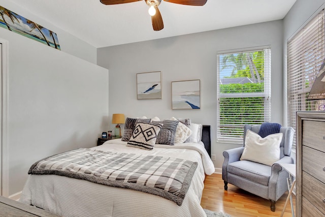 bedroom with multiple windows, ceiling fan, and light hardwood / wood-style flooring