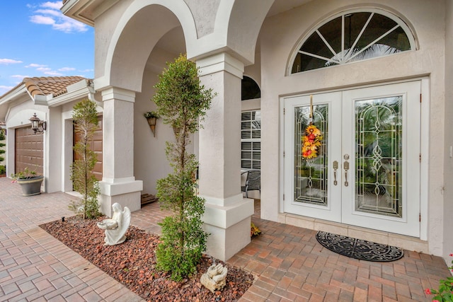 entrance to property with french doors and a garage