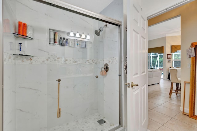 bathroom featuring tile patterned flooring and a shower with shower door