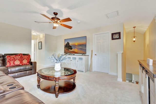 living room featuring ceiling fan, light colored carpet, and vaulted ceiling