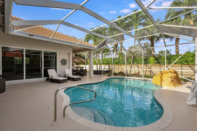 view of pool with a lanai and a patio