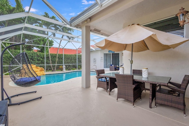 view of swimming pool with glass enclosure and a patio