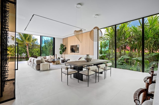 dining space featuring concrete floors and a wall of windows