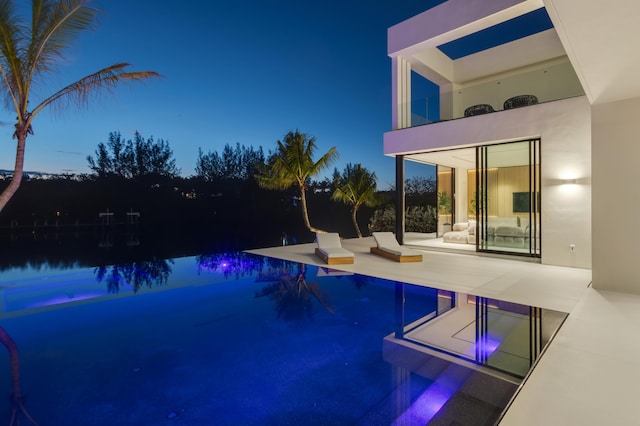 35 Spoonbill Rd, Manalapan, FL 33462 - pool at twilight with an outdoor pool and a patio